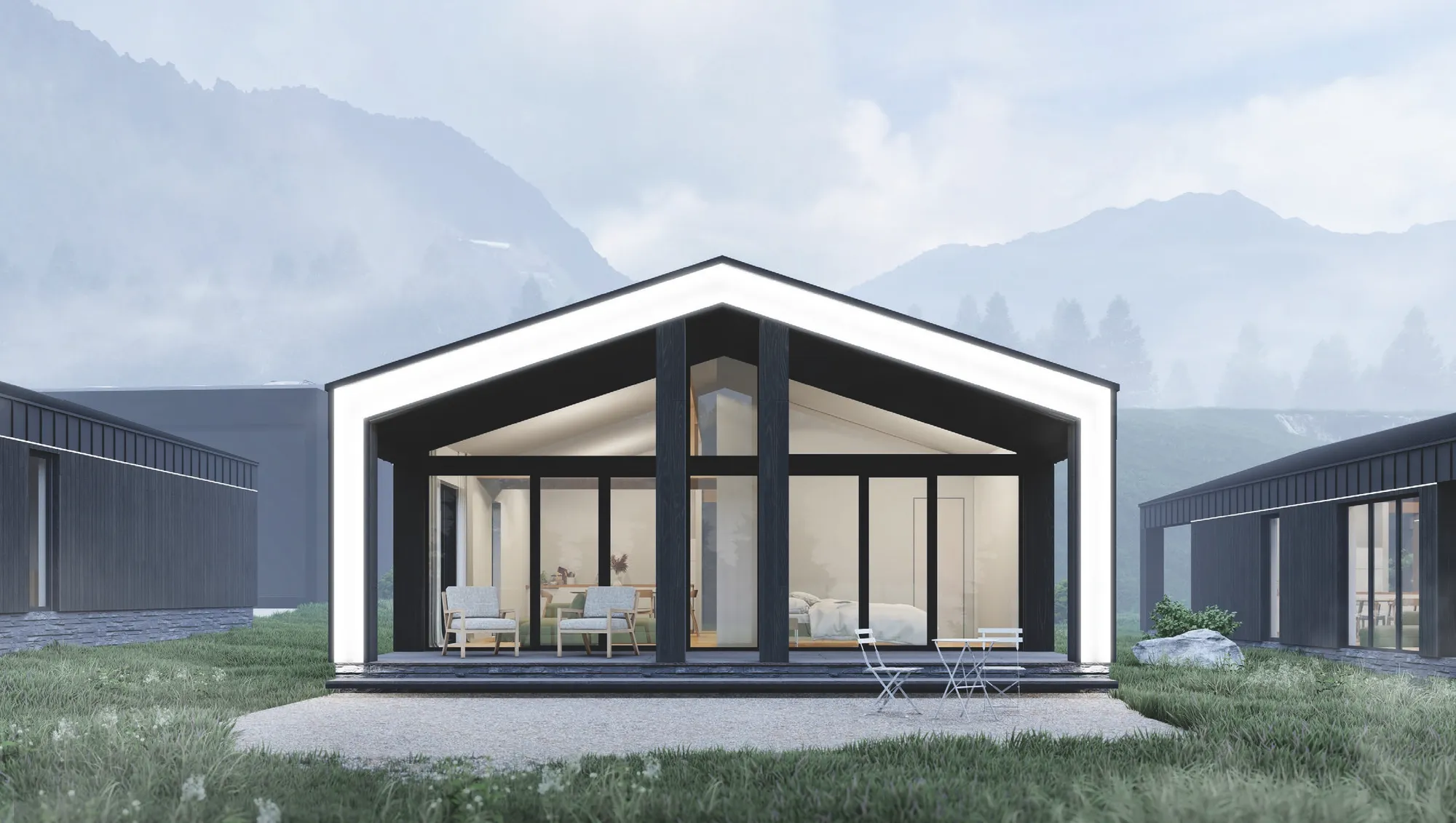 Gästehaus mit großem Panoramafenster vor Bergkulisse